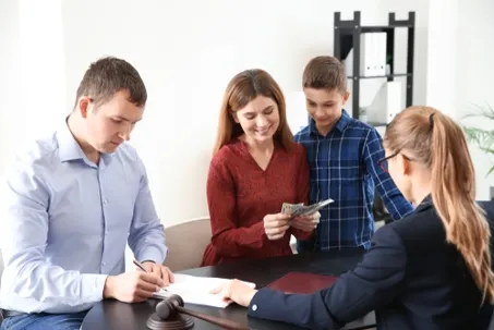 A family with a child meeting with a professional advisor or lawyer.